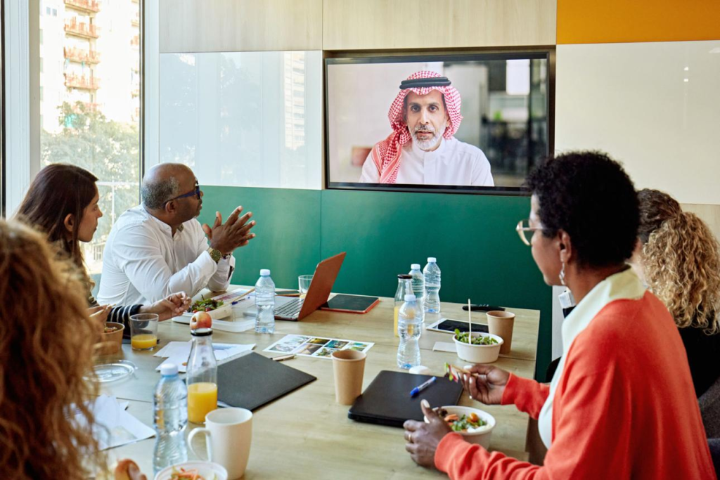 Business professionals using Logitech video conferencing technology in a modern meeting room for seamless collaboration in Riyadh